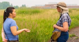 Two women talk in the grasslands east of Battle Creek Regional Park.